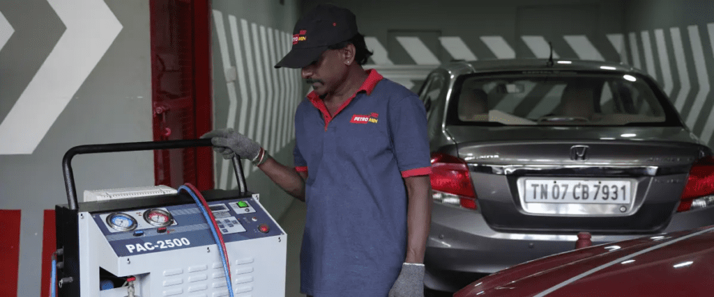 A Petromin Express employee observing a machine's functioning.
