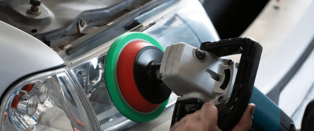 A vehicle's headlight being serviced.