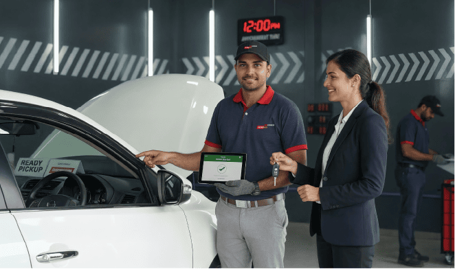 A Petromin Express employee inspecting a vehicle.