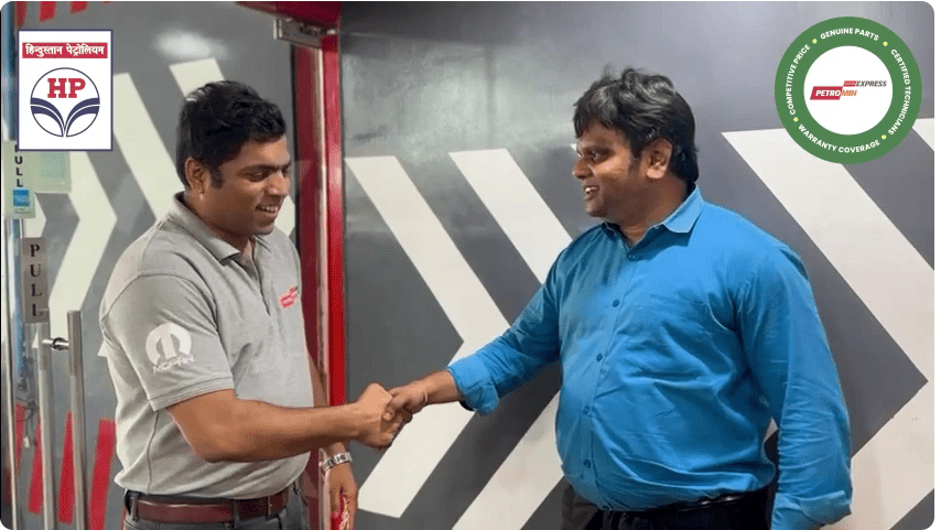 An employee of Petromin Express shaking hands with a customer, gaining thoughts from their experience with the brand.