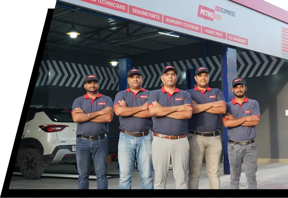 A group of Petromin Express employees standing together in front of a service centre.
