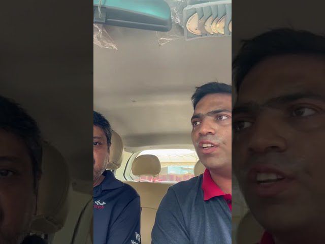 An employee of Petromin Express in conversation with a customer.